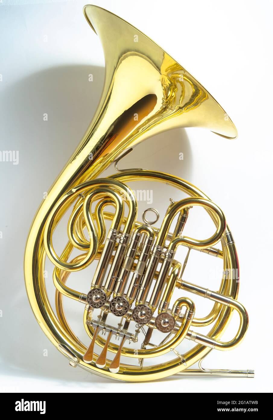 Yellow full double BbF French horn brass wind musical instrument on a white  background Stock Photo - Alamy