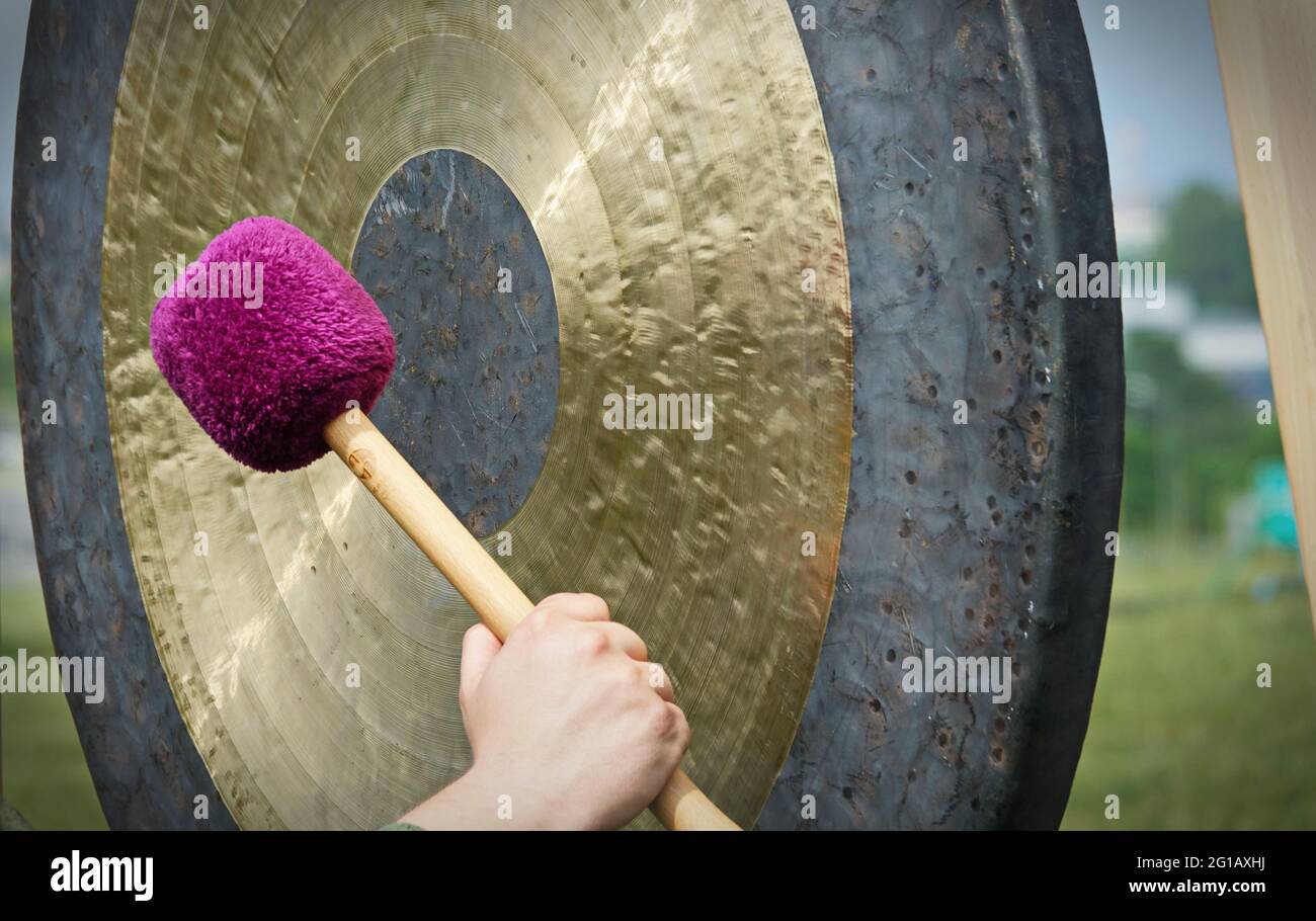 Sound therapy with gong, It is important to be completely relaxed in order to be able to accept the sound and vibration of Gong to the fullest. Stock Photo