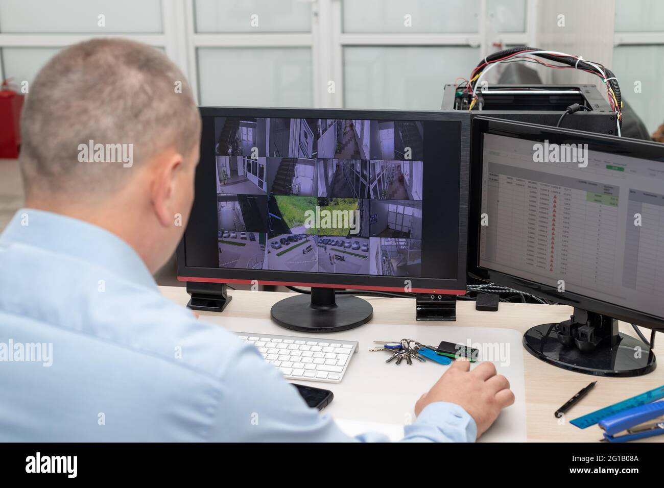 CCTV security system operator monitoring video cameras Stock Photo