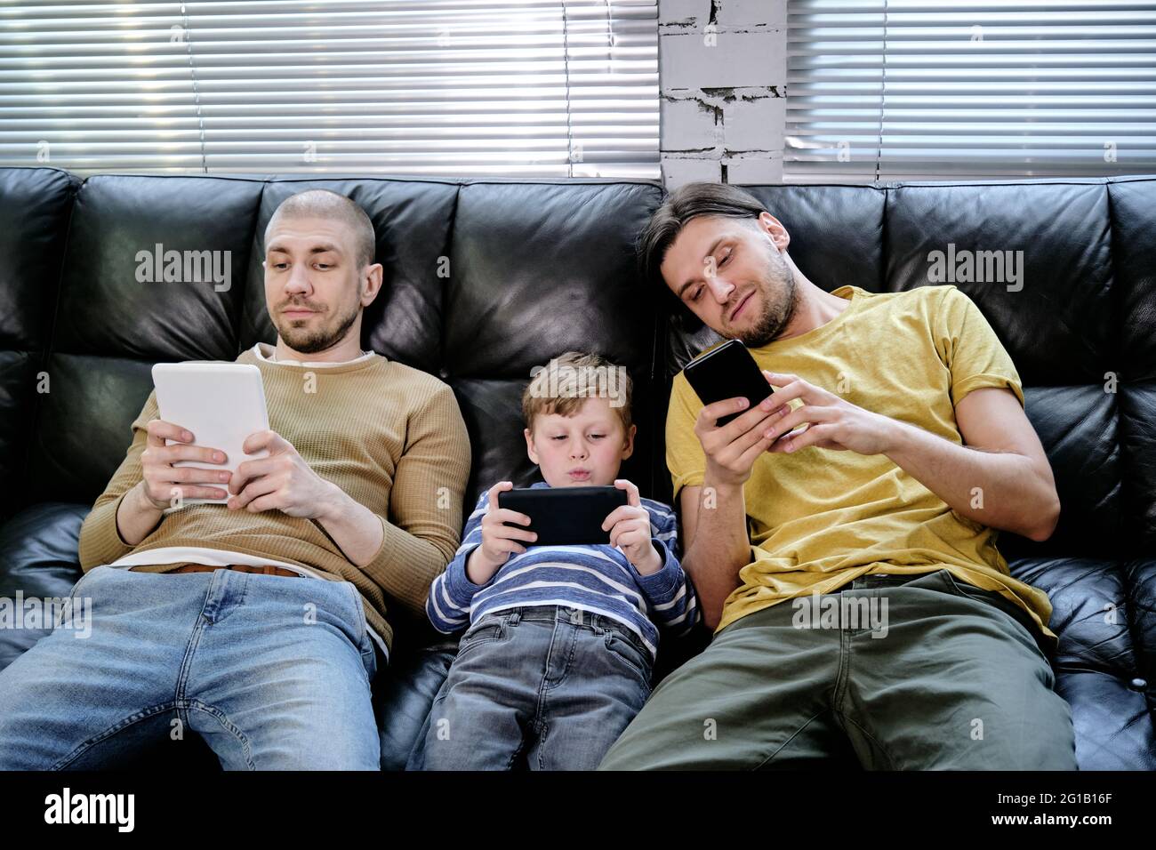 Two men on sofa hi-res stock photography and images - Alamy