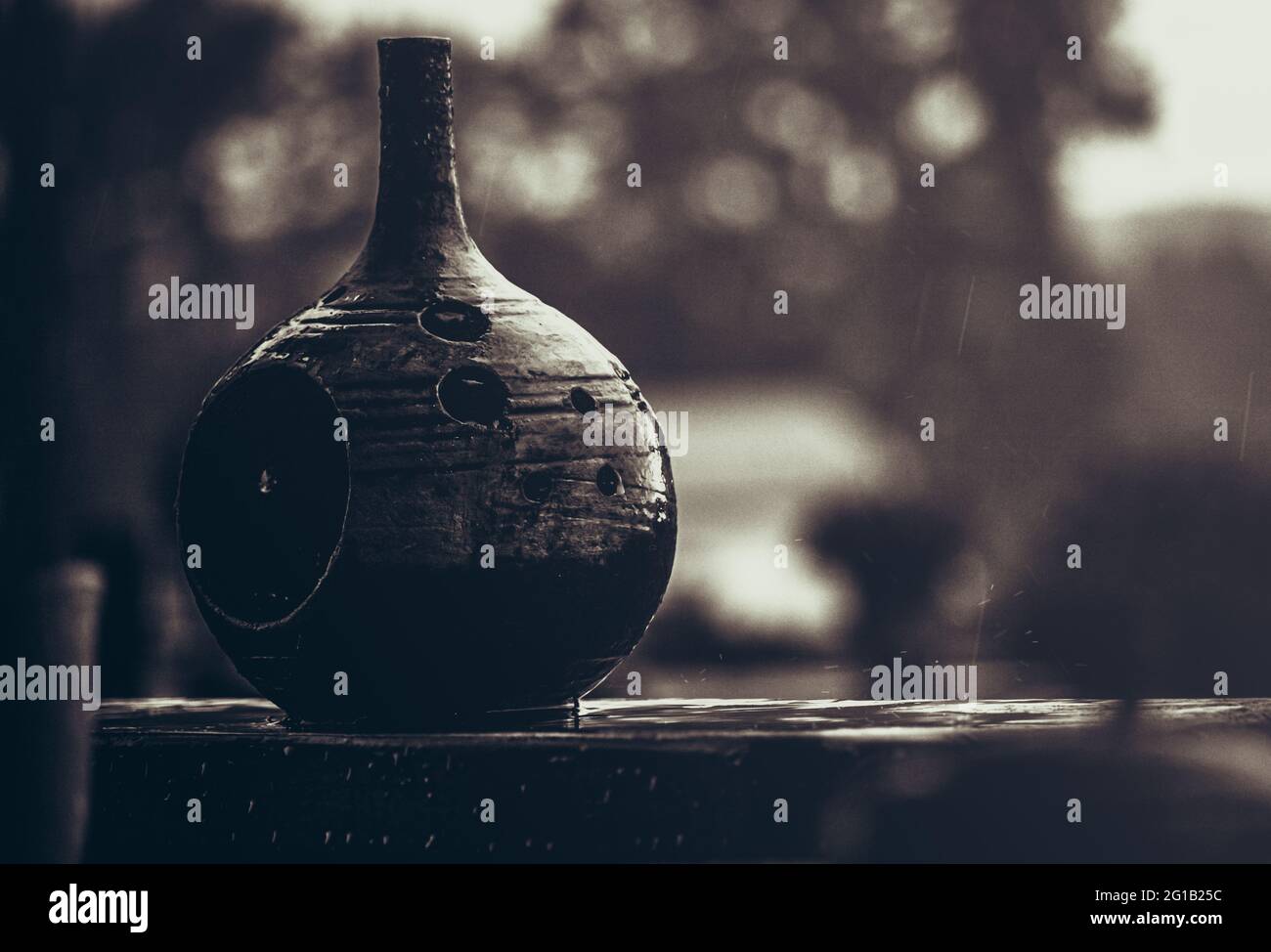 Close-up of a vase as a decorative tea light holder in still life style. Melancholy mood camera obscura decoration as a vase. Bowling Ball Surreal. Stock Photo