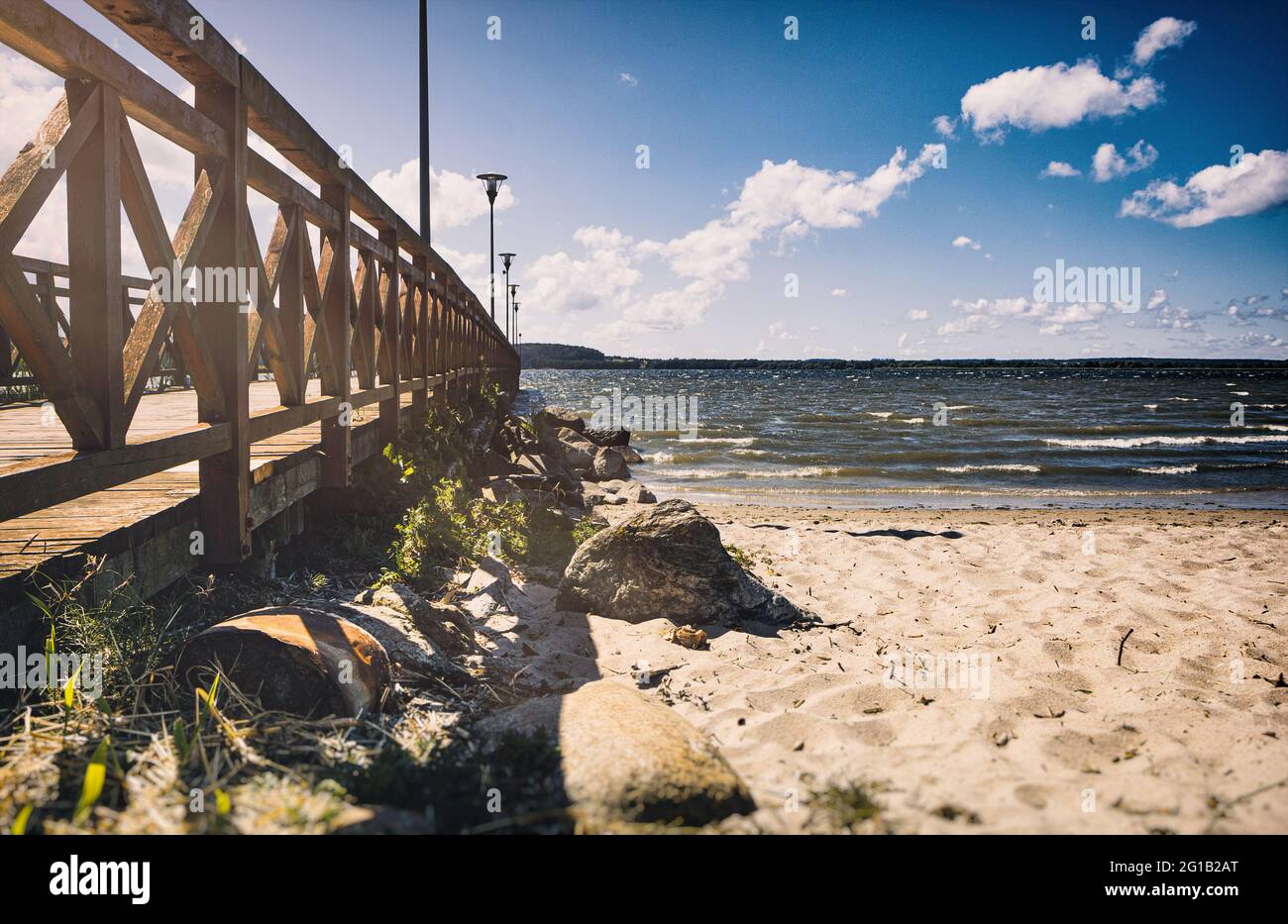 Jetty on a beautiful sandy beach in Poland. Jetty on the beach of Lake Zarnowitz in Poland on a warm summer day overlooking the open sea. Stock Photo