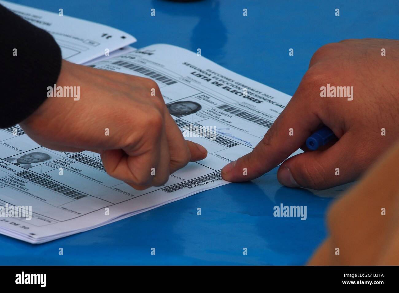 Lima, Peru. 06th June, 2021. A woman putting her fingerprint on the voting roll. Peruvian citizens queue up maintaining sanitary measures to cast their vote in the 2021 runoff elections between Pedro Castillo and Keiko Fujimori, held amid a great surge of Covid-19 infections. Credit: Fotoholica Press Agency/Alamy Live News Stock Photo