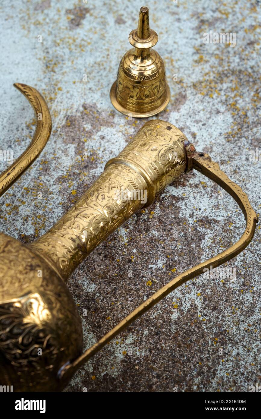 close-up of an antique golden magic lamp lying on the floor Stock Photo