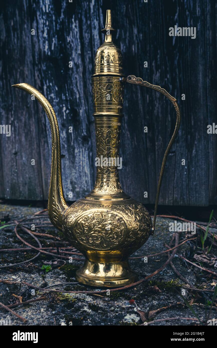 close-up of an antique golden magic lamp on the floor Stock Photo