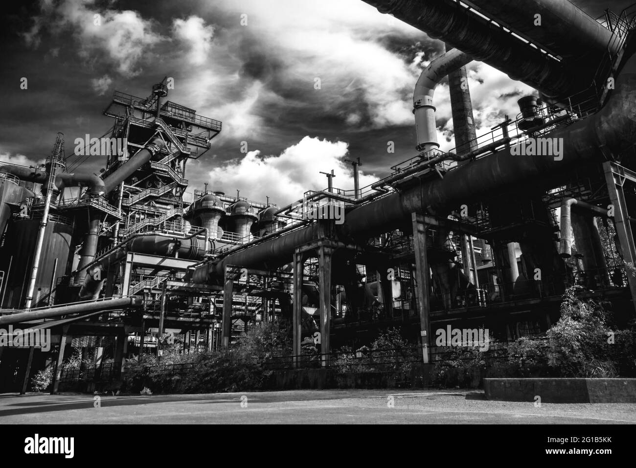 Steel factory and ironworks in the landscape park Duisburg Nord with closed blast furnace and ironworks as a panorama. Stock Photo