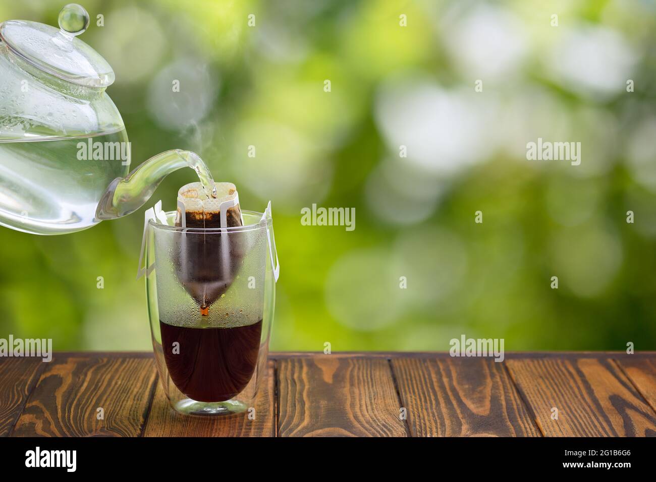 hand drip coffee in glass on wooden table Stock Photo