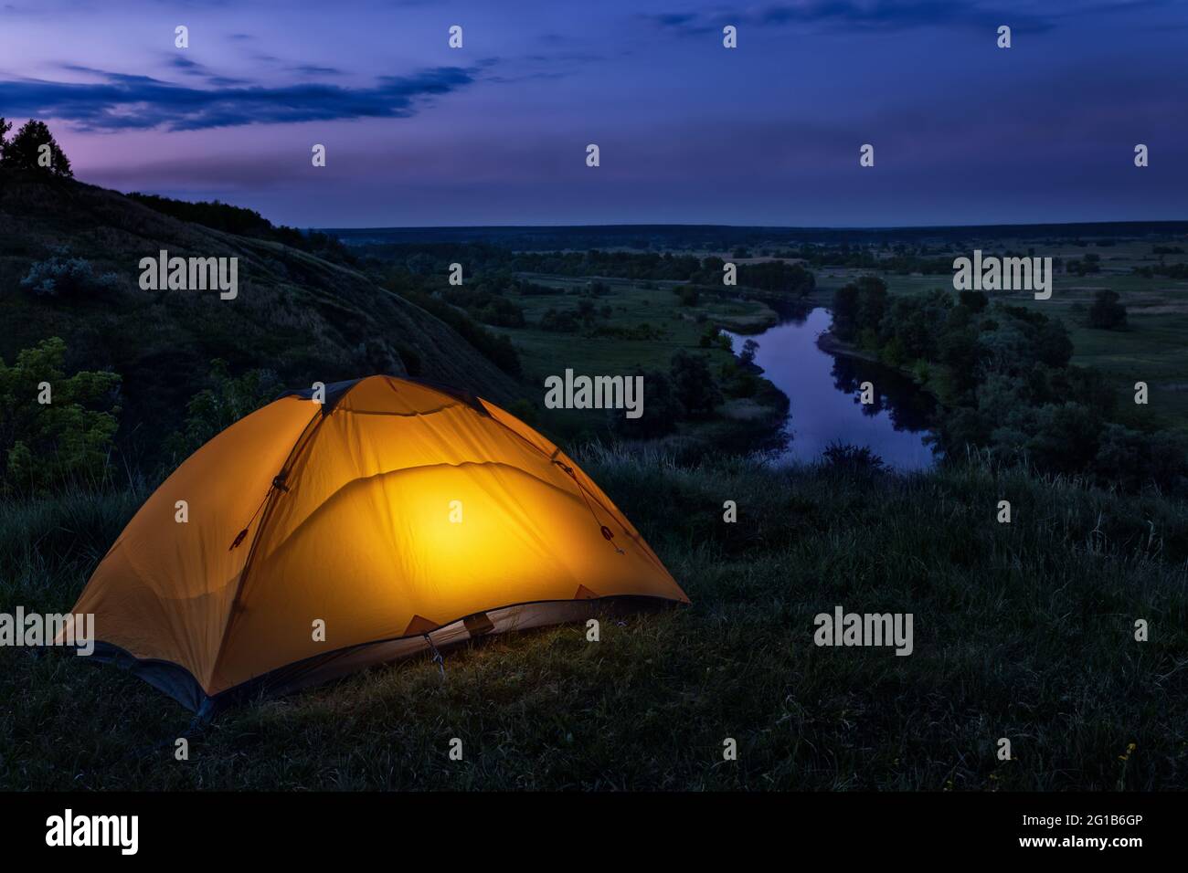 tourist tent on the hill near the river Stock Photo - Alamy