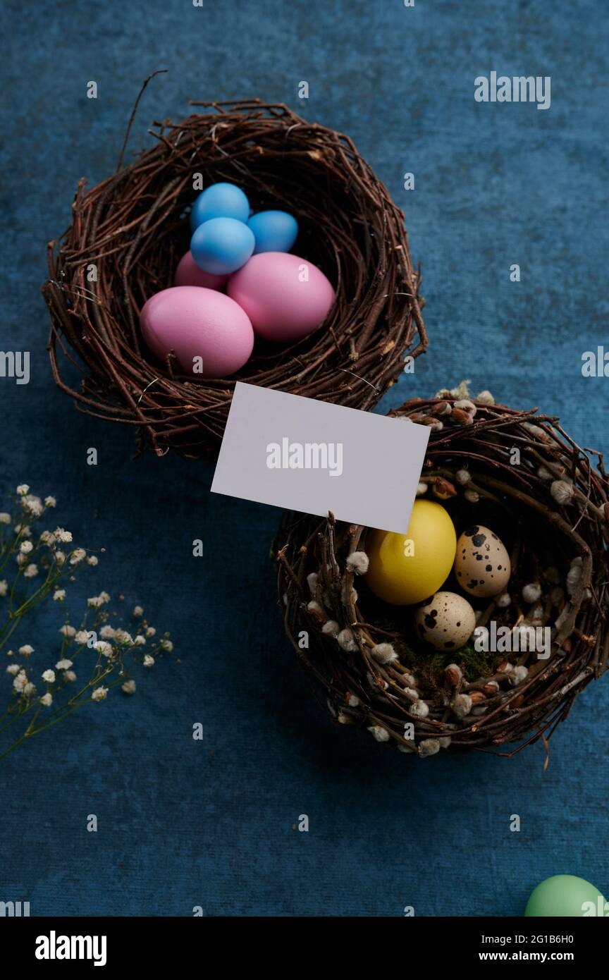 Easter eggs in decorative nests and greeting card Stock Photo