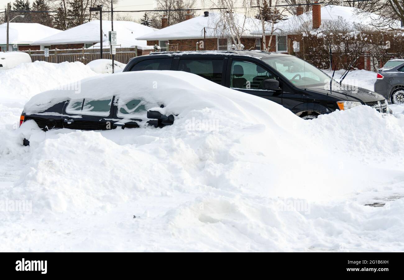 Large pile of snow covering a car during the harsh 2014 Winter in Toronto as result of the polar vortex or superstorm. Stock Photo