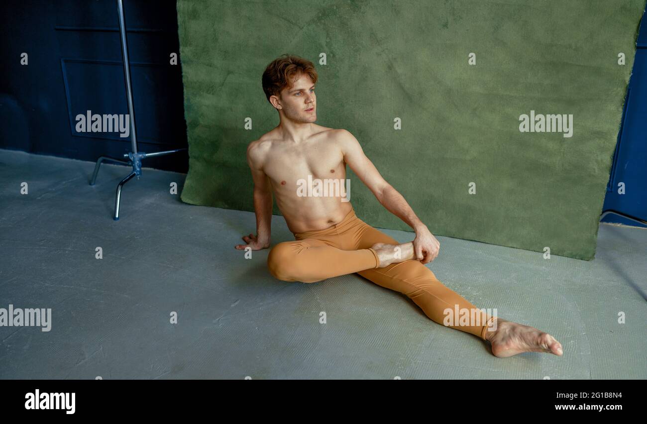 Ballet dancer sittiing on the floor, dancing class Stock Photo