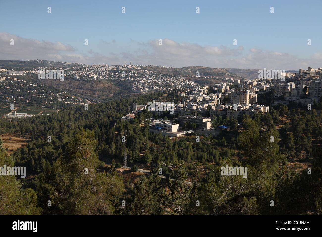Biblical Judean Hills seen from the Jerusalem forest with Pine Trees,  Har Nof, Jerusalem neighborhood on the right, plus towns Motza & Mevaseret Zion Stock Photo