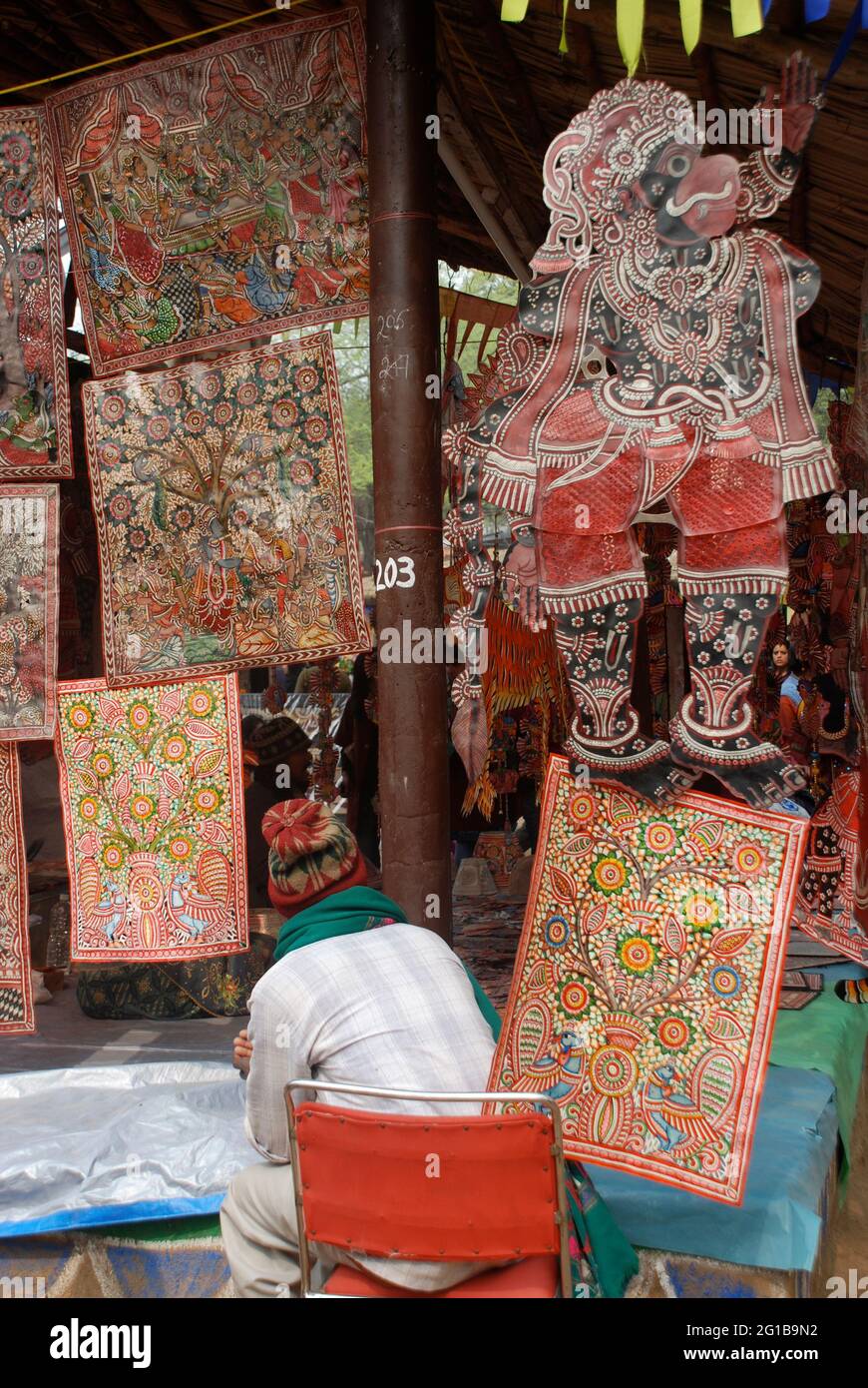 A craftsman from Andhra Pradesh waits for customers at his stall, at the annual Surajkund Mela in Delhi, India. The fair showcases arts and crafts from across India. February 22, 2006. Stock Photo