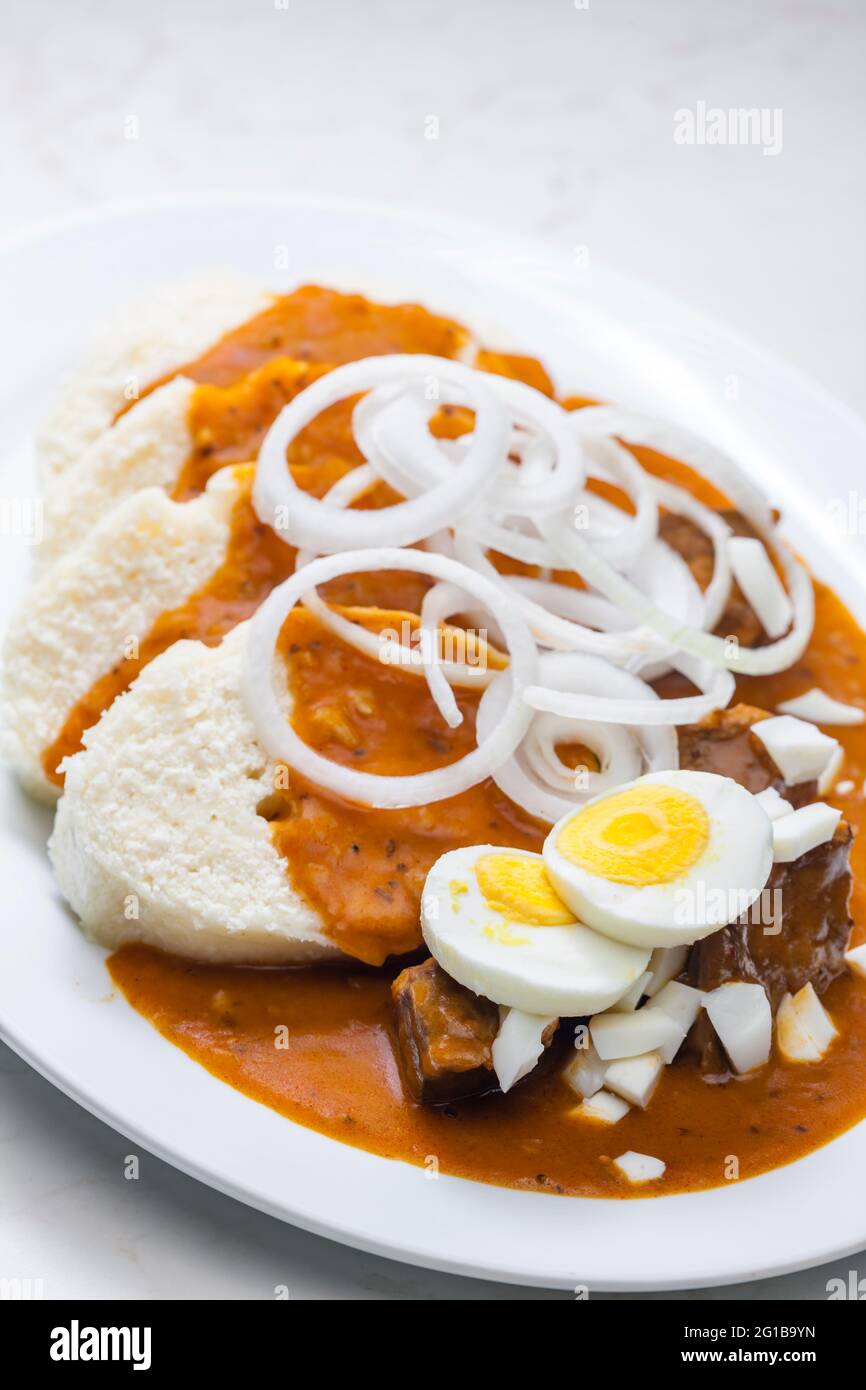 beef goulash with onion rings, boiled egg and dumplings Stock Photo