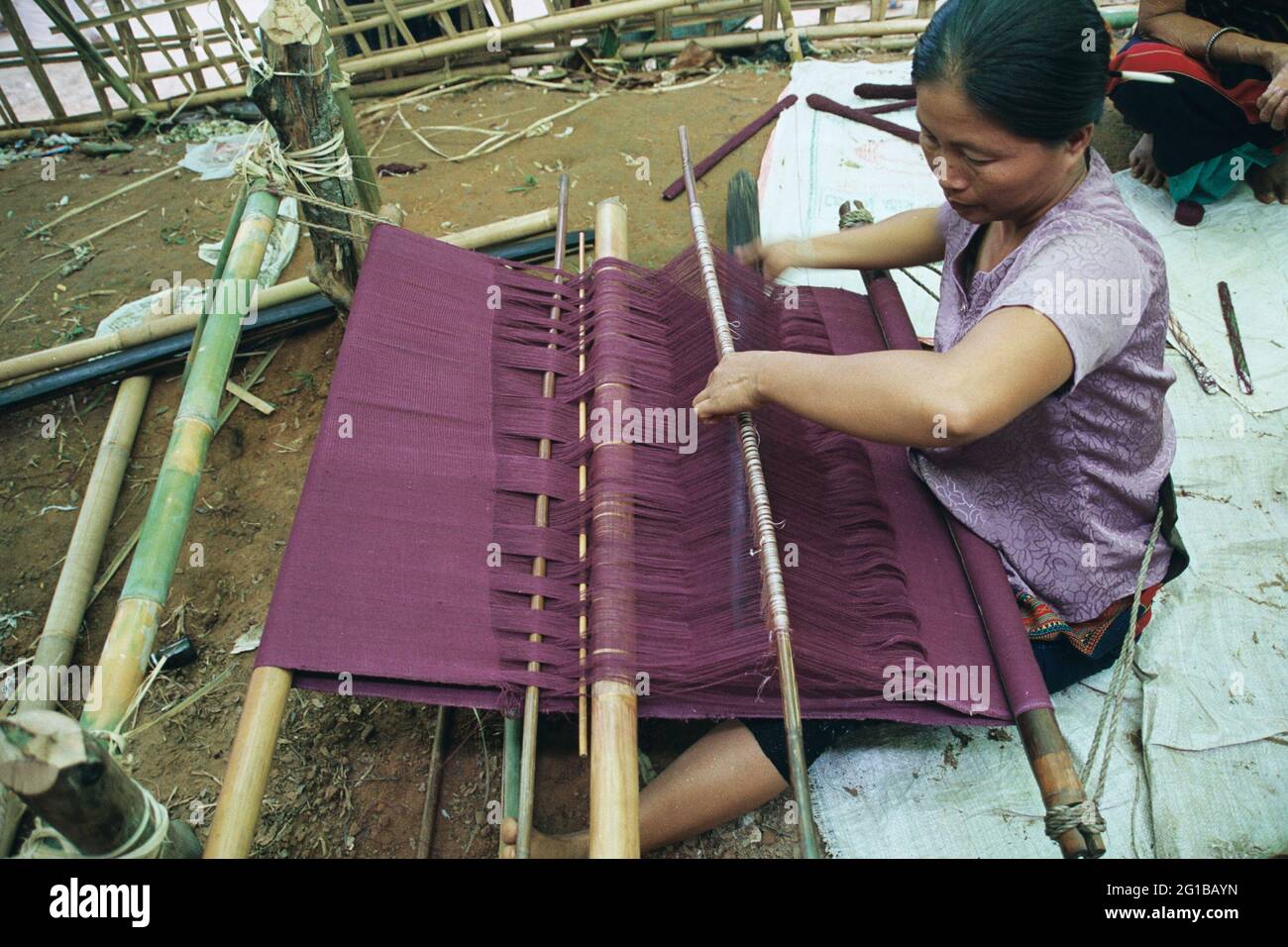 A woman from Chakma community weaves the Kathina Chibarang, a robe for Buddhist monks, to offer it at the annual Kathina Chibarang festival at Raj Ban Bihar in Rangamati.  Bangladesh. August 22, 2006. Stock Photo