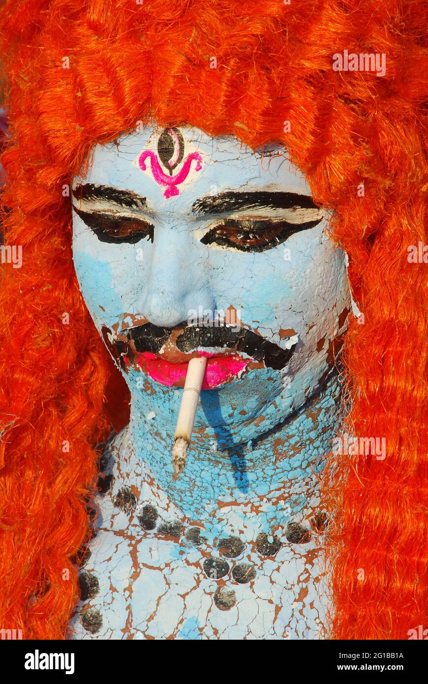 shiv tobacco A man disguised as Lord Shiva, smokes a cigarette, during the immersion of  Goddess Durga after a weeklong Durgapuja festival in chittagong.  Bangladesh. October 21, 2007 Stock Photo