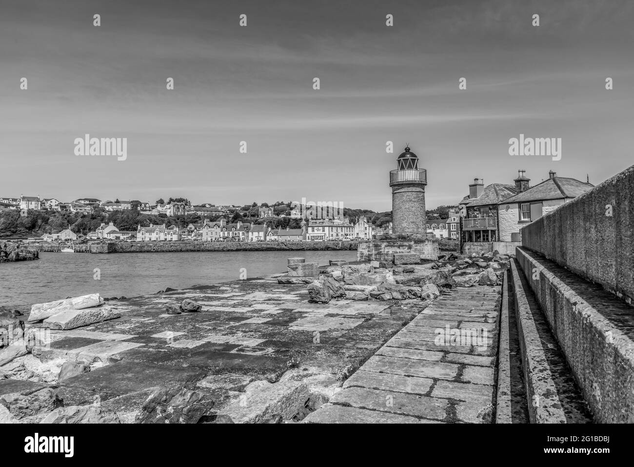 This is of lighthouse at the coastal town and past ferry port of Portpatrick on the Dumfries and Galloway peninsula on the west coast of Scotland Stock Photo