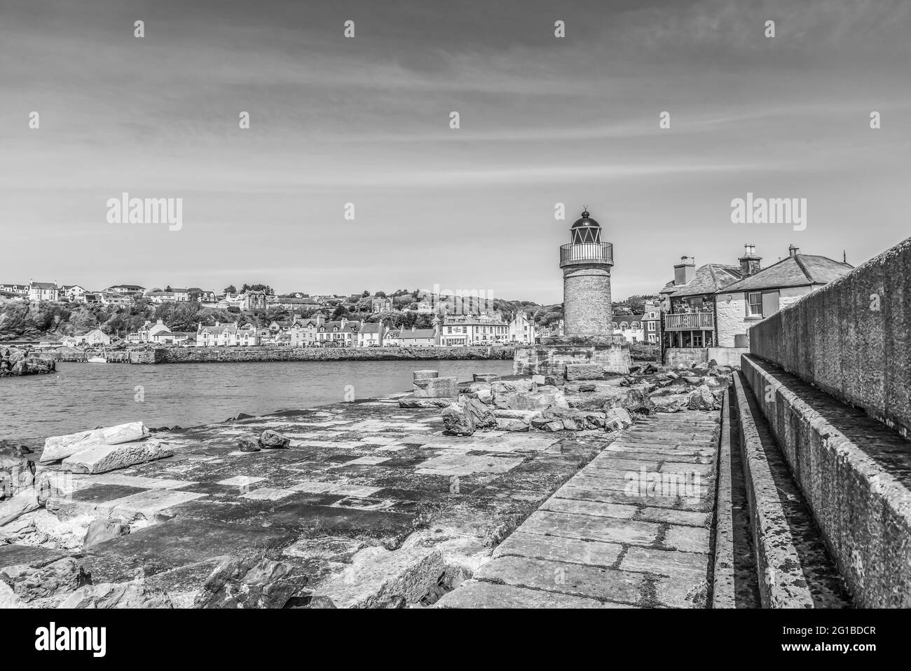 This is of lighthouse at the coastal town and past ferry port of Portpatrick on the Dumfries and Galloway peninsula on the west coast of Scotland Stock Photo