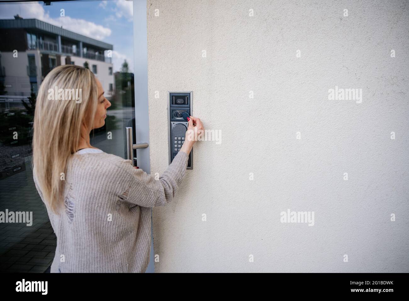 The woman enters the apartment. Uses the remote control to open the ... - Off-Grid Apartment Remote Controlled Door