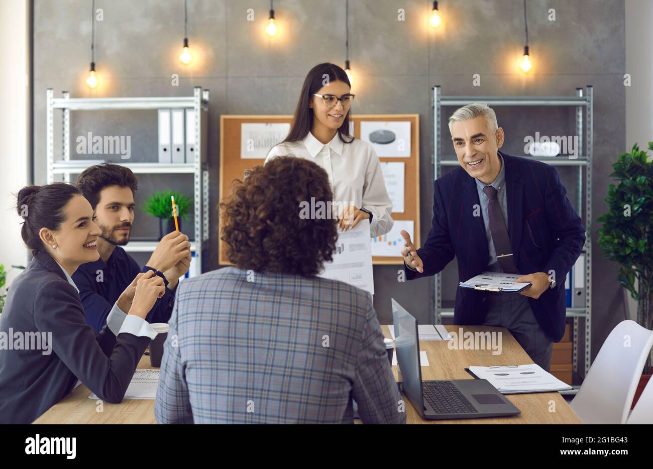 Group of workers giving a presentation to colleagues in a corporate team meeting Stock Photo
