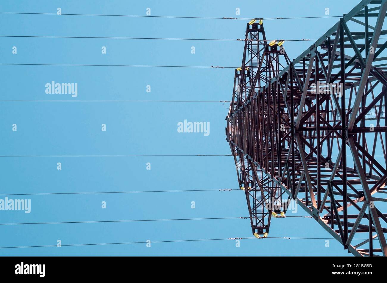 High voltage tower with electricity transmission power lines against ...