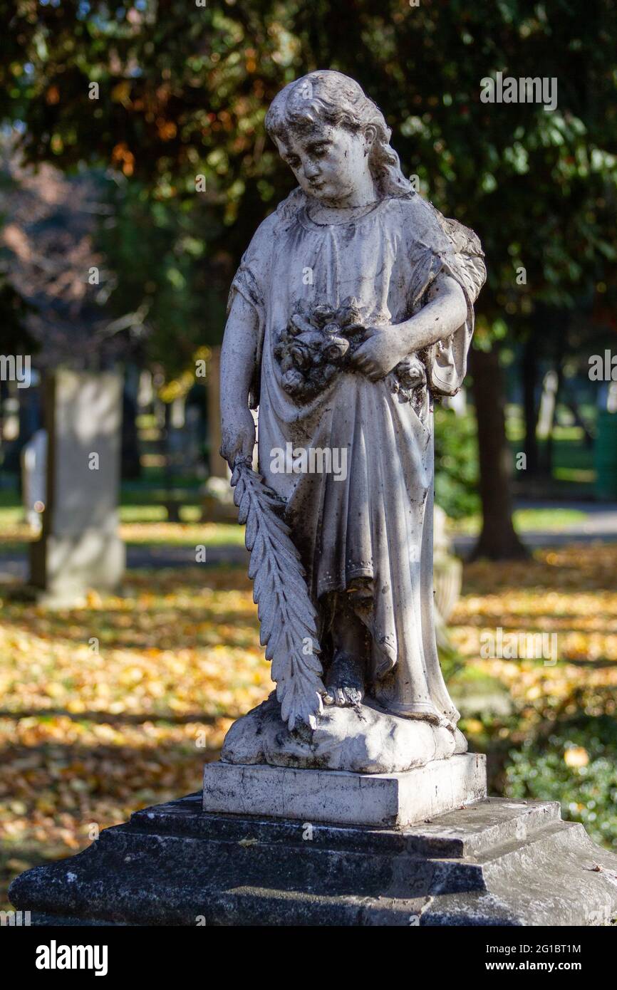 A statue of an angel on an ancient tombstone at the Ondrejský cintorín (St. Andrew's Cemetery) in Bratislava. Bratislava, Slovakia. 2020-11-07. Stock Photo