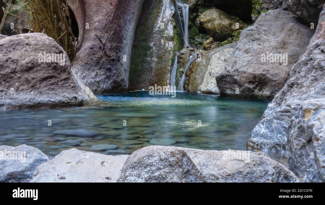 small waterfall with clear turquoise water on tropical island Tenerife in Masca Valley, Tenerife Spain Stock Photo