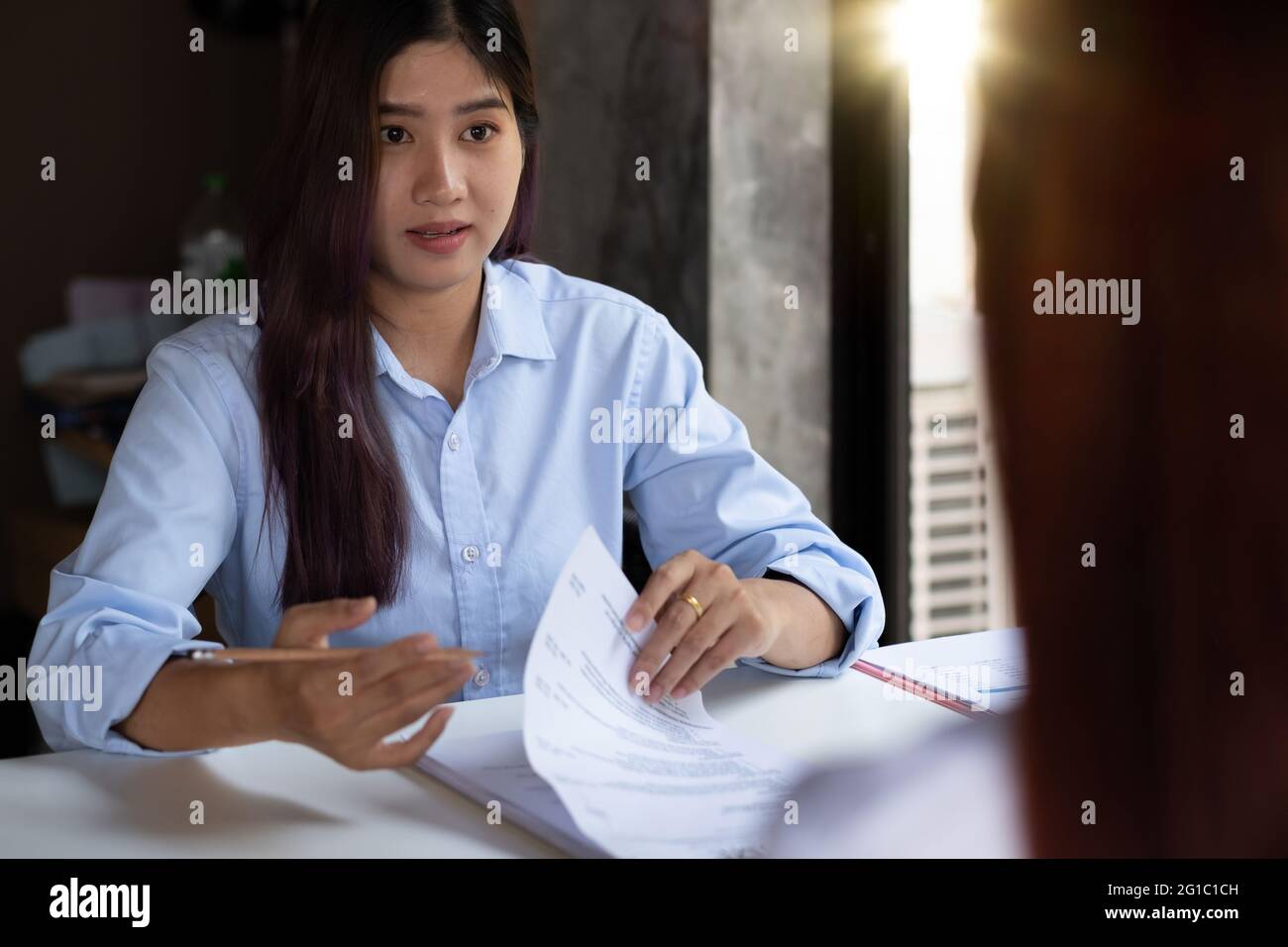 Businesswoman holding resume and talking to female candidate, during corporate meeting or job interview - business, career and placement concept. Stock Photo