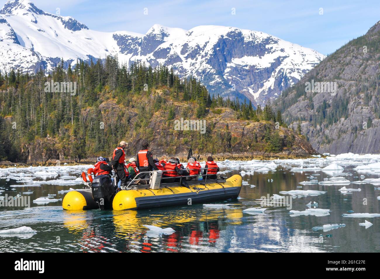 Cruise passengers travel via skiff through the icebegs from Leconte Glacier Stock Photo