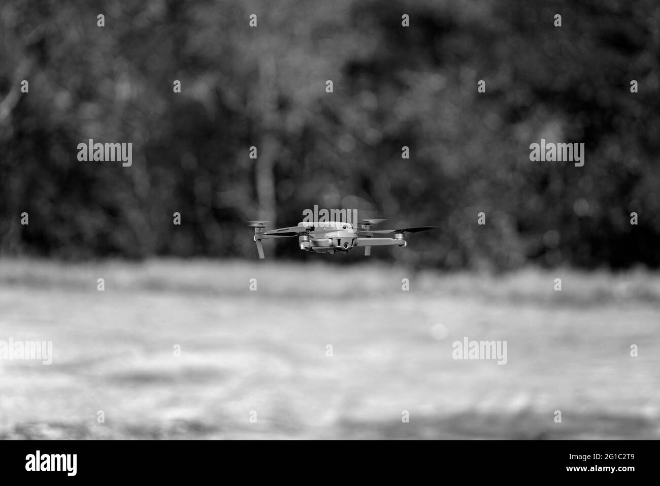 A drone hovering over the landscape in black and white Stock Photo - Alamy
