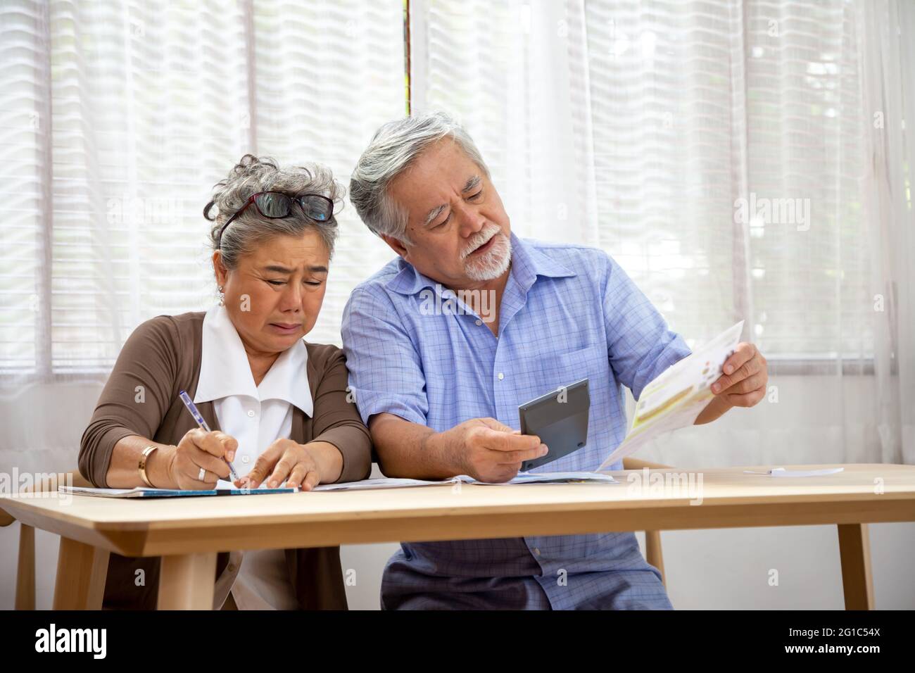 asian-senior-couple-serious-worried-with-calculating-bills-to-pay-per-month-or-debt-retired