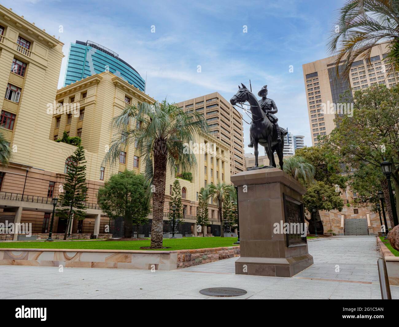 General view of the Anzac Square in Brisbane Australia. Park with trees and palm trees, green grass. Office buildings and hotels in the background. Stock Photo
