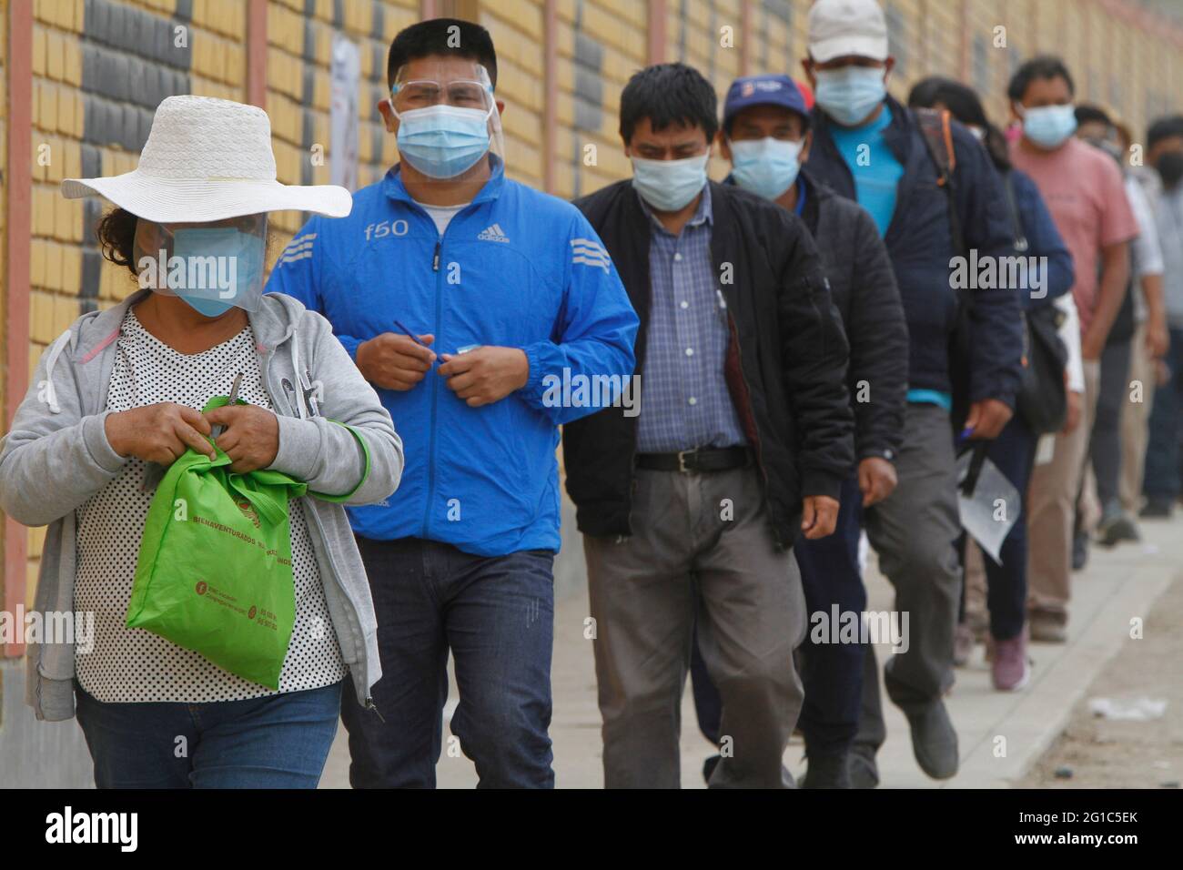 Lima. Peru. 6th June 2021. Presidential Elections. People lining up to cast their vote outside a public school where the voting took place. The school is located in the district of 'Manchay', one of the poorest communities on the outskirts of Lima. Stock Photo