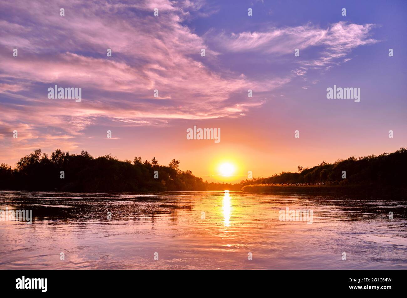 Magic atmosphere of a romantic evening; golden sunset on the river Stock Photo