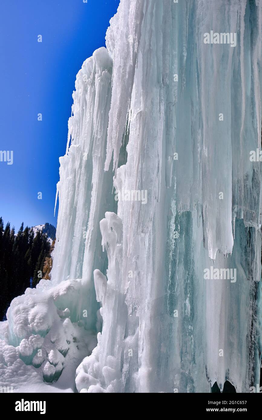 Phenomenon of nature: huge ice stalagmites formed on the site of the waterfall in the winter season Stock Photo