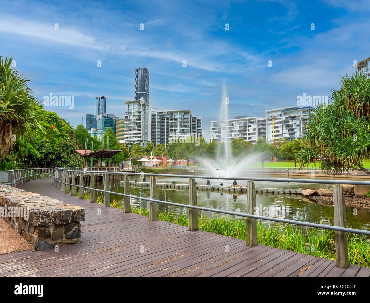 Park lands and apartment building at Roma Street in Brisbane, Australia. Fountain and lake, residential and office buildings in the background. Stock Photo