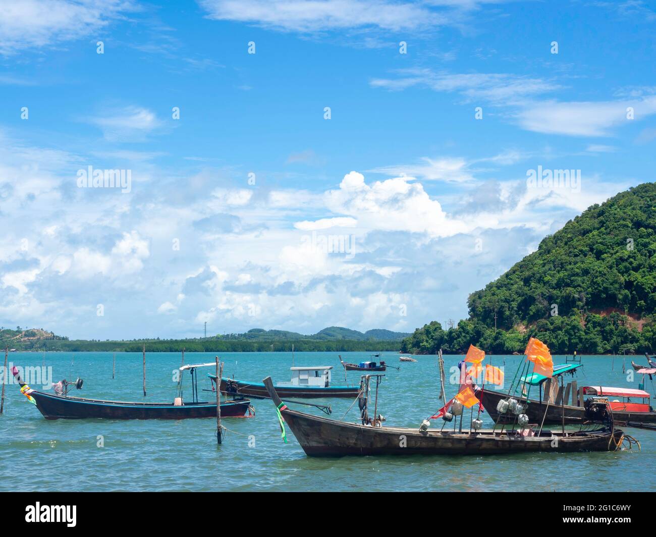 Beautiful seascape summer background. Many local fisherman longtail boat on the sea and sky background on a sunny day in Thailand. Stock Photo