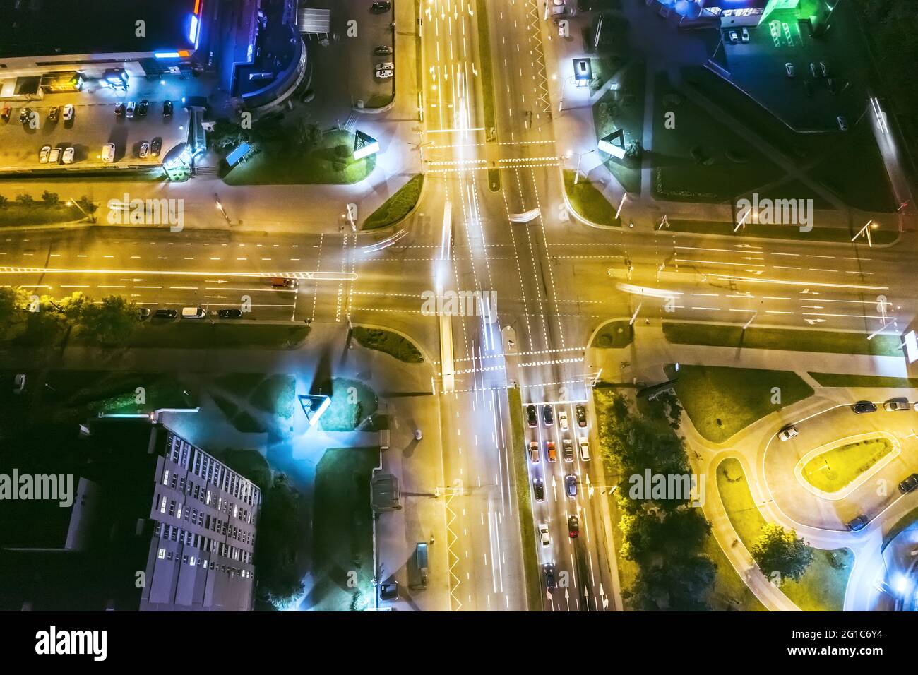 car traffic on road intersection at night city. aerial top drone view Stock Photo