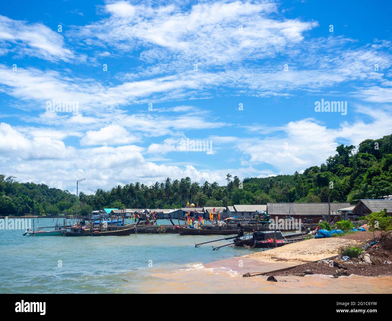 Beautiful seascape summer background. Scene of fisherman village with many local longtail boat on the sea and sky background on a sunny day in Thailan Stock Photo