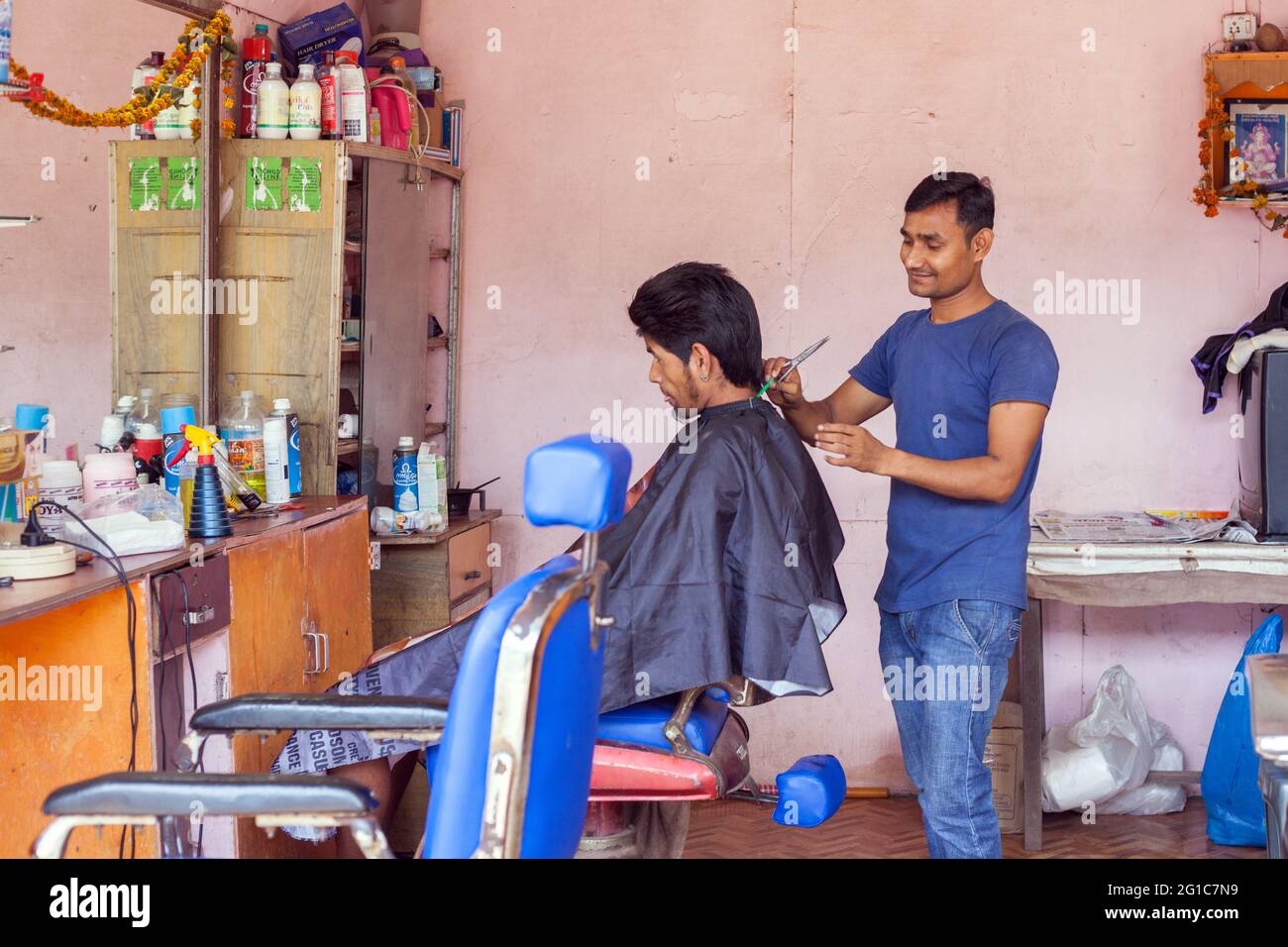 Indian male with bouffant hairstyle having his hair cut in salon, Agonda, Goa, India Stock Photo