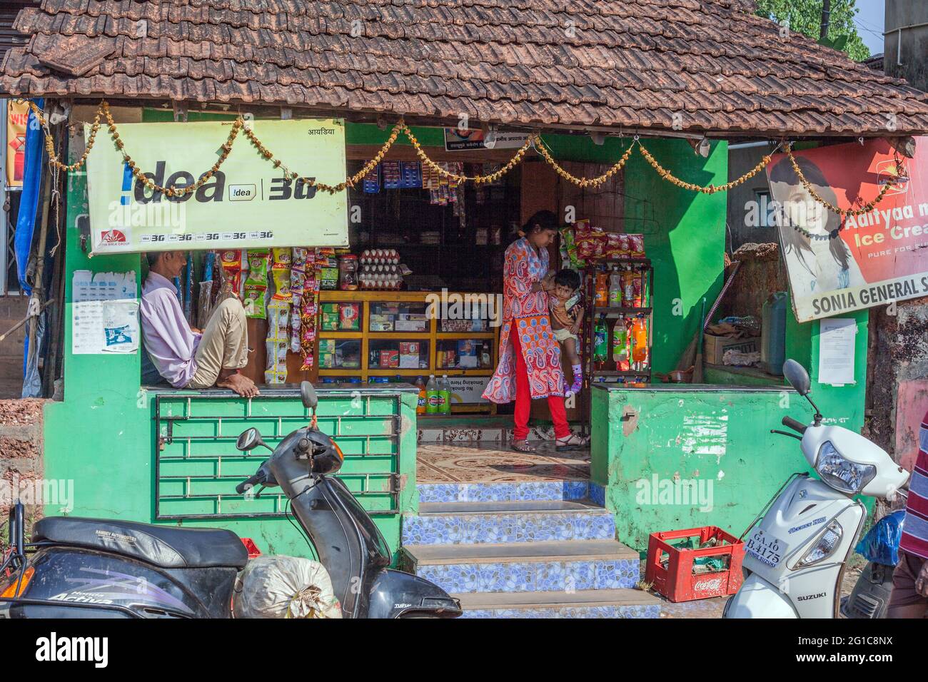 Indian female wearing ethnic salwar kameez shopping for conveniences at the local Sonia General Store, Agonda, Goa, India Stock Photo