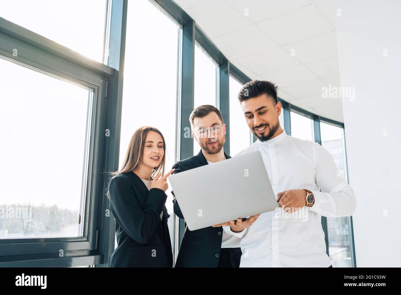Two office workers show their new project to the boss Stock Photo