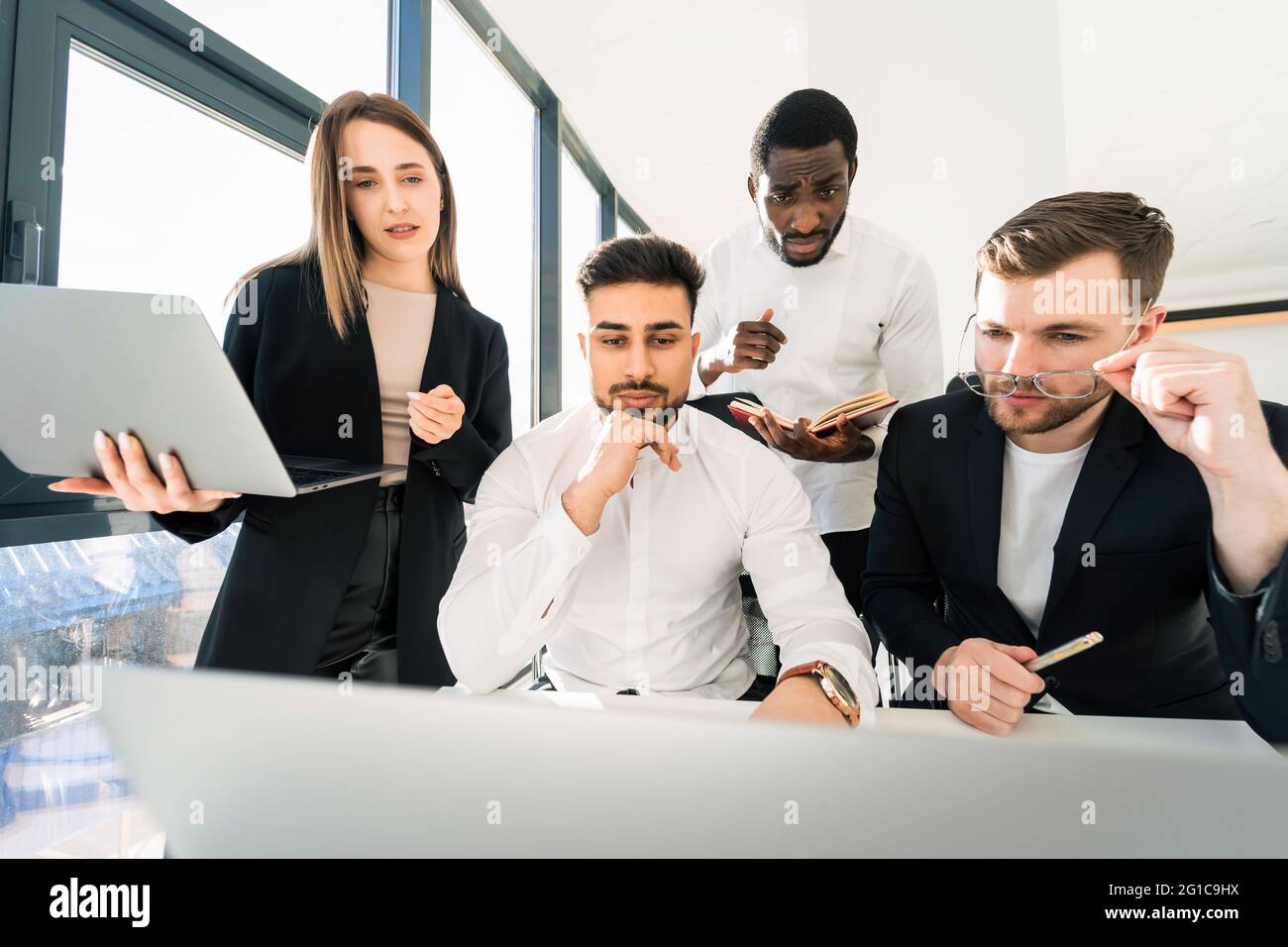 Multiracial team of programmers working together on a new assignment Stock Photo