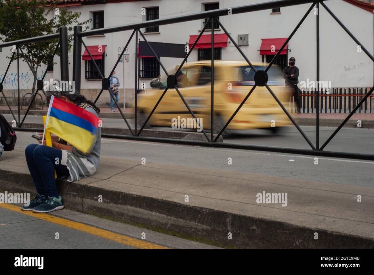 Bogota, Colombia. 06th June, 2021. A woman holds a Colombian national flag upside down as people and indigenous Misak community gather to wait for the arrival of the Inter-American Comission on Human Rights (CIDH) amid police brutality and unrest during anti-government protests that reach at least 70 dead in the past month of demonstrations, in Bogota, Colombia on June 6, 2021. Credit: Long Visual Press/Alamy Live News Stock Photo