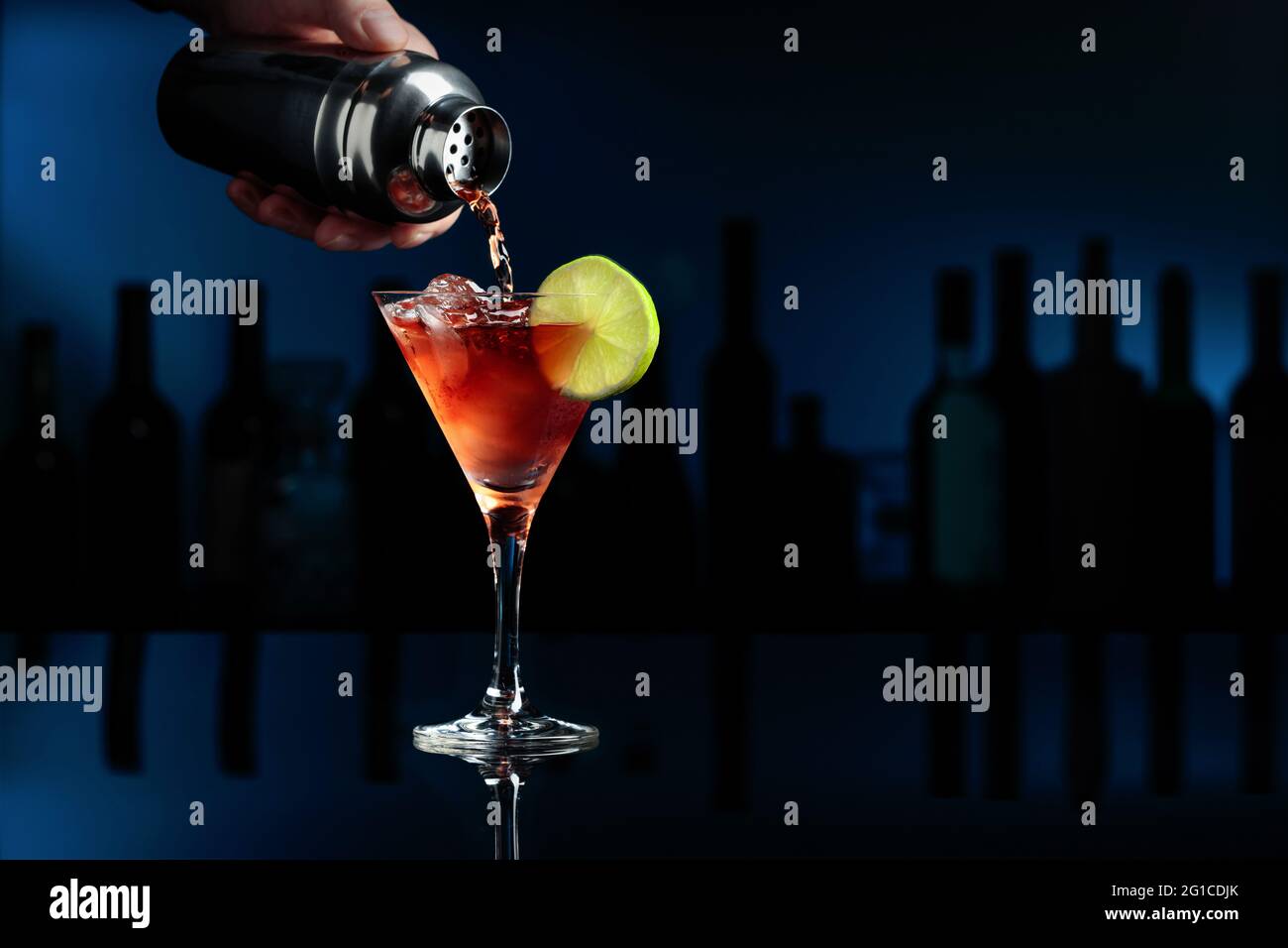 Cocktail "Barbados" on a black reflective background. The bartender