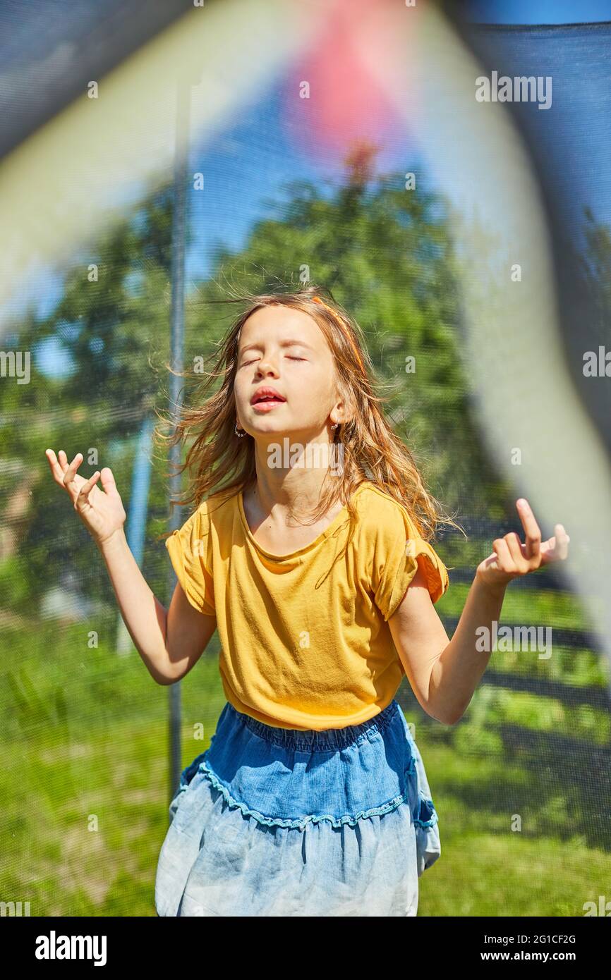 Little girl jumping up and down in hires stock photography and images