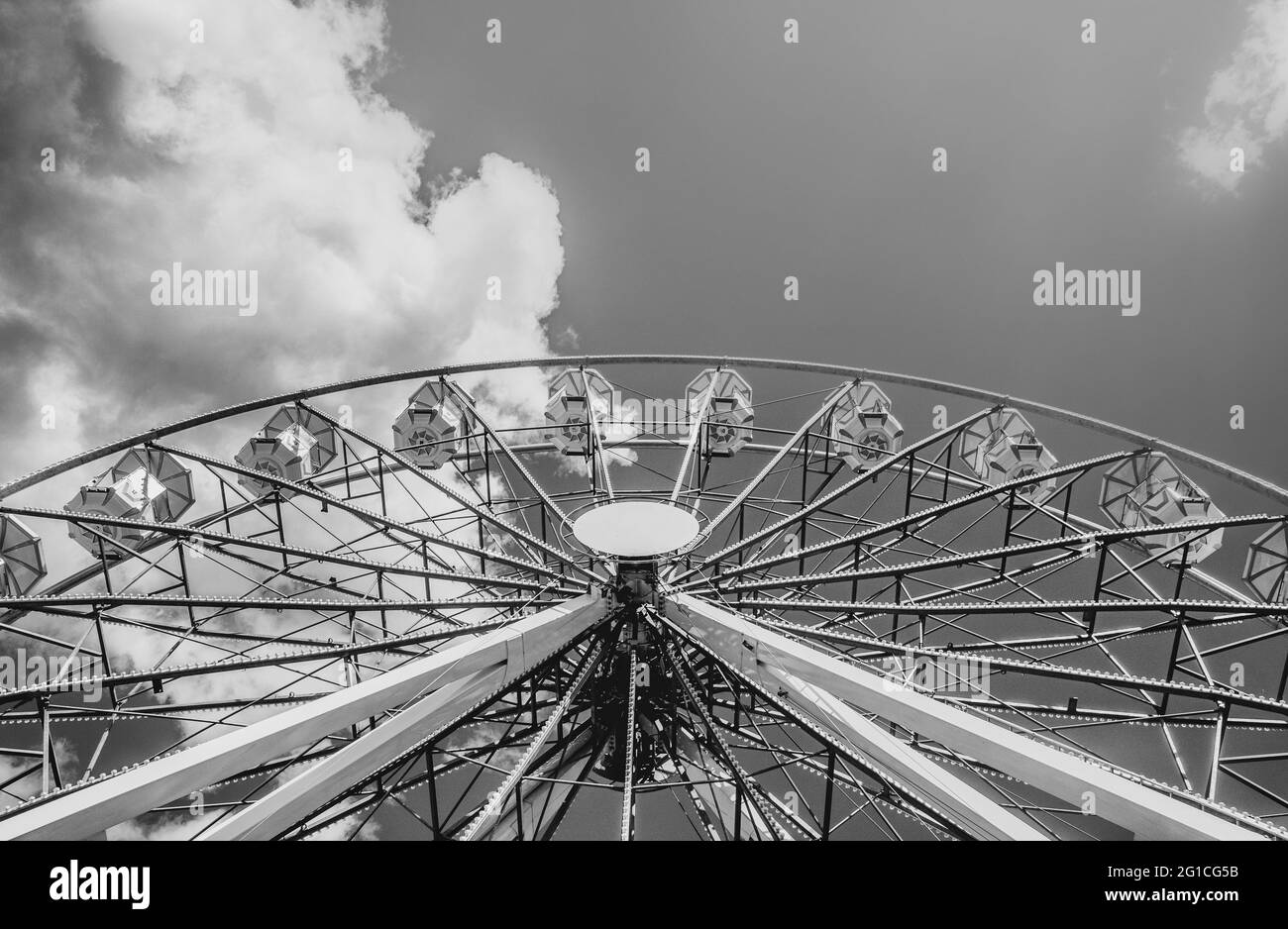 Ferris wheel amusement ride in summer at Gdansk Bay in Poland - symmetry vanishing point photography in amusement park on the coast of Gdansk Lodon Ey Stock Photo