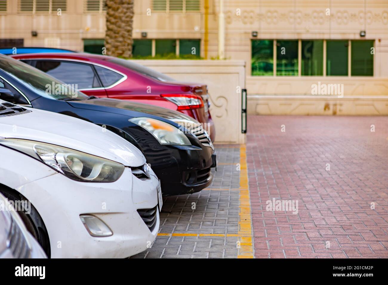 DUBAI, UAE - MARCH 2020: Cars on the parking in a street of Dubai Stock Photo