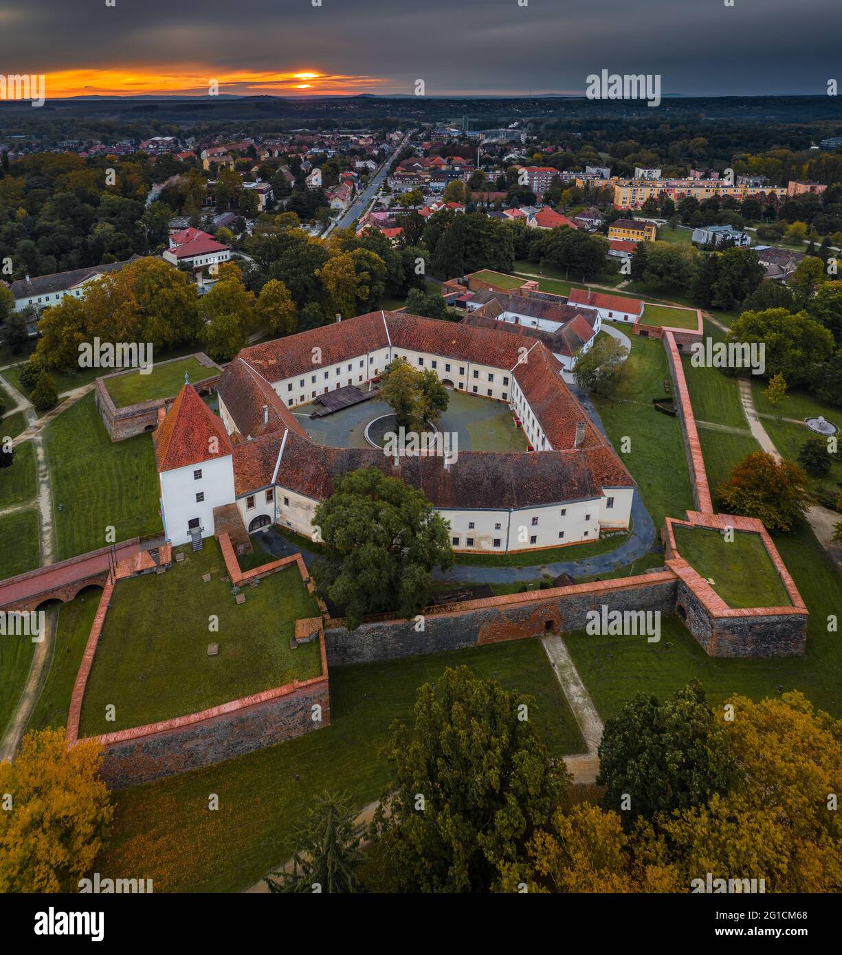 Sarvar, Hungary - Aerial panoramic view of the Castle of Sarvar (Nadasdy castle) at autumn from above with a beautiful dramatic sunrise at background Stock Photo