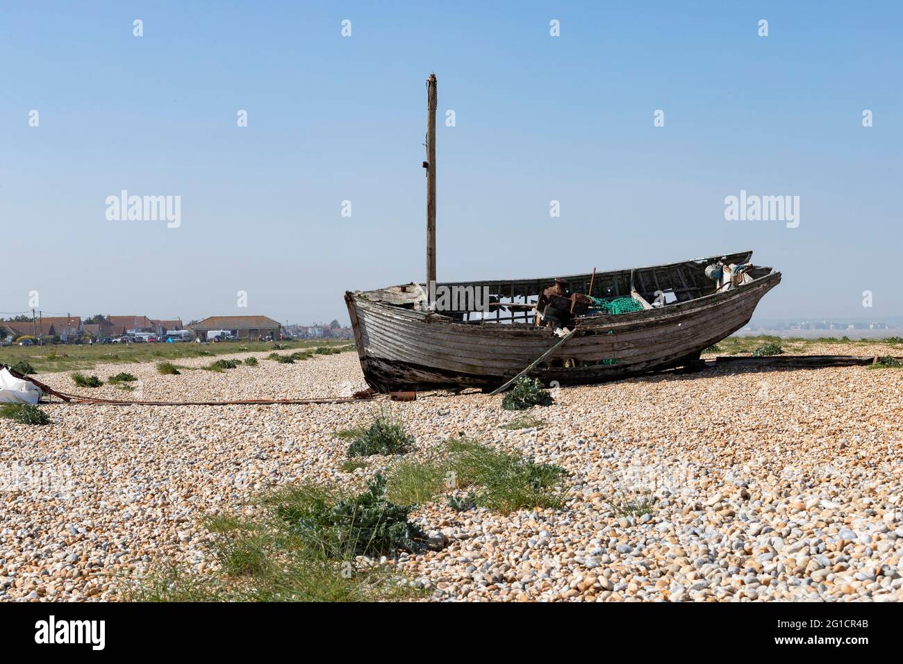 Abandoned fishing boat decaying on the shingle at Dungeness, Kent ...